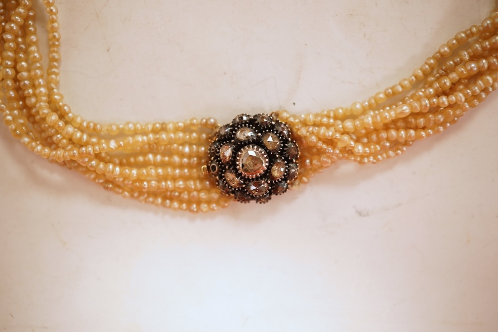 An eight-strand seed pearl choker necklace, with a rose-cut diamond clasp, length 34cm, pearls untested; together with a single strand graduated cultured pearl necklace, length 40cm, clasp stamped 9ct, Condition: good, s